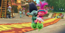 This image released by DreamWorks Animation shows the characters Branch voiced by Justin Timberlake, center left, and Queen Poppy voiced by Anna Kendrick, center right, in a scene of the animated film "Trolls Band Together." (DreamWorks Animation via AP)