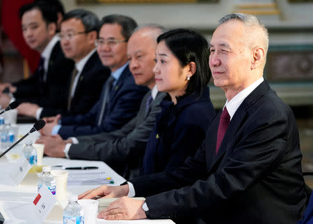 China's Vice Premier Liu He (R), Chinese vice ministers and senior officials pose for a photograph before the start of US-China Trade Talks at the White House in Washington, U.S., February 21, 2019. REUTERS/Joshua Roberts