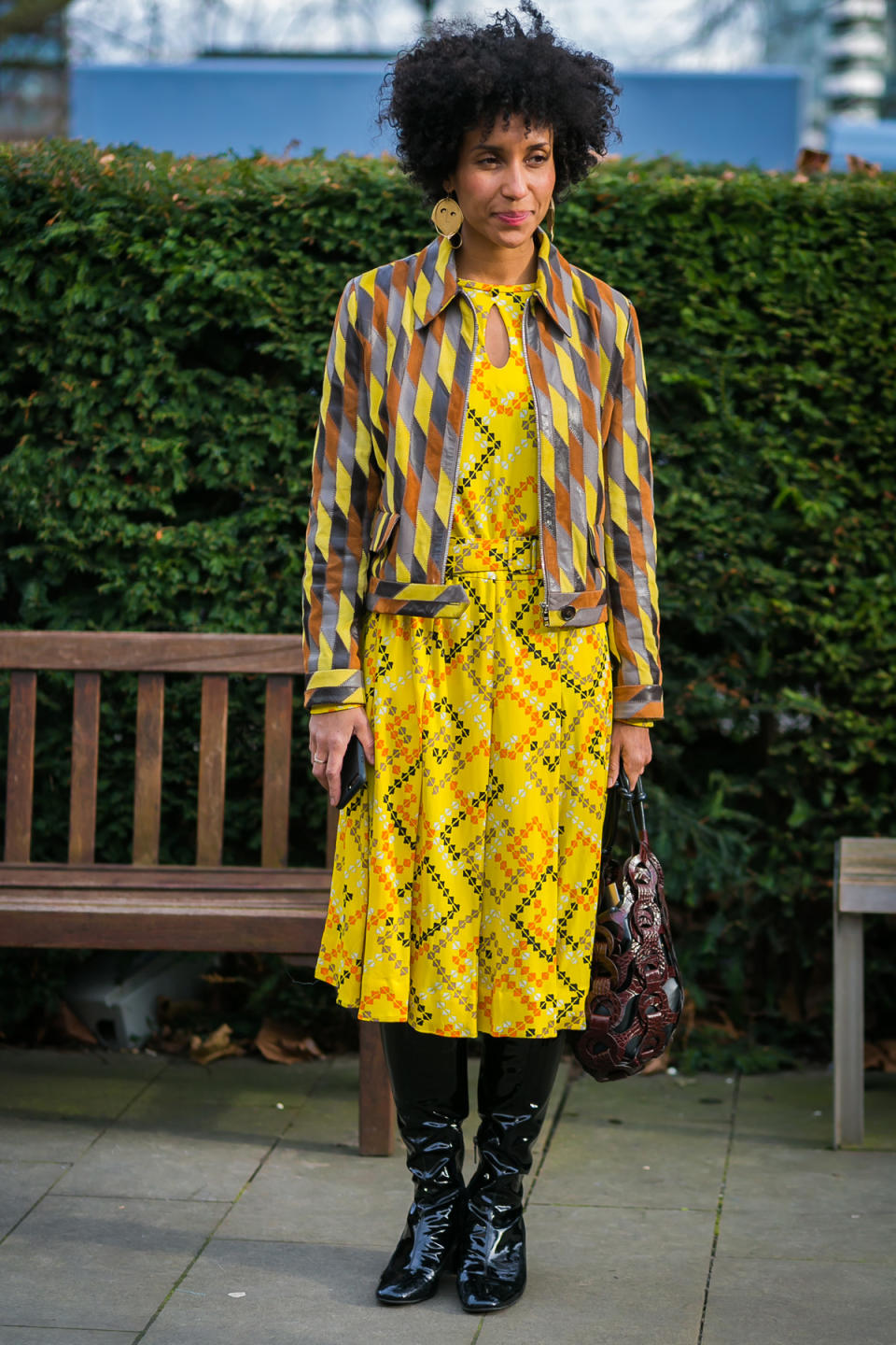 Vogue editor Chioma Nnadi shows off her way with print-mixing in a yellow dress and patchwork jacket.
