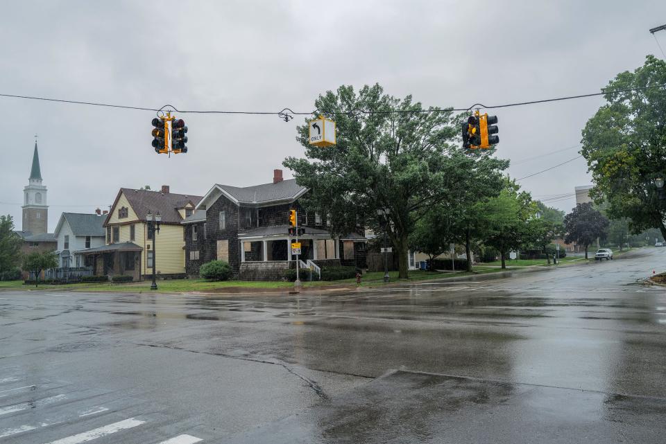 At the intersection of Ottawa and Walnut Streets, a new mixed-use building named the Capitol Tower is planned where the houses are now. Photo: Sunday, Aug. 6, 2023.