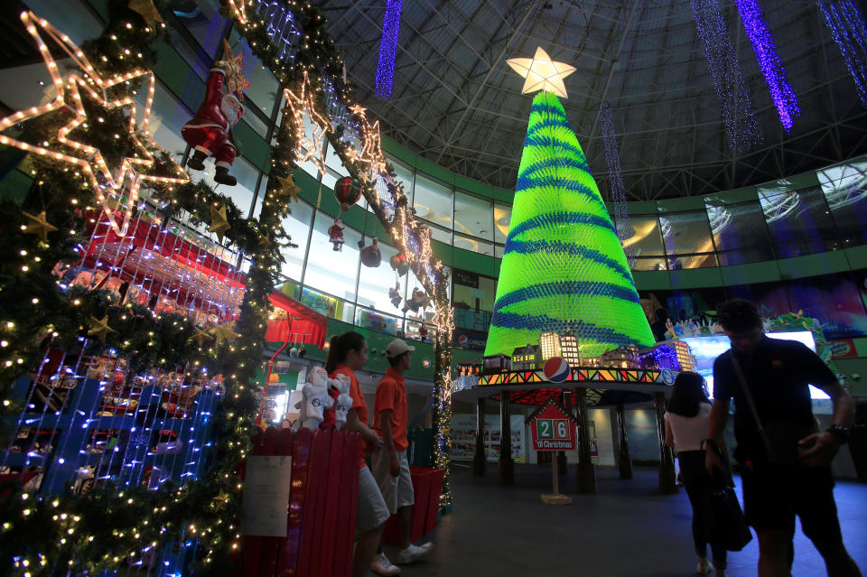 Parkgoers walk past&nbsp;a 15-foot Christmas tree made of 15,000 recycled plastic bottles at the Manila Ocean Park in Manila, Philippines.