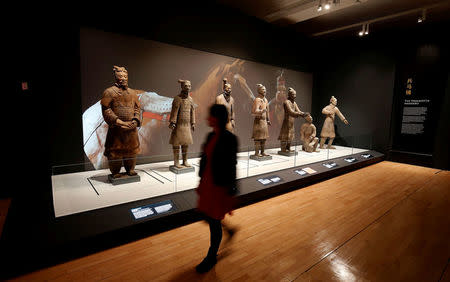 A member of the museum staff walks past a display of Terracotta Warriors which guarded the tomb of China’s First Emperor, Qin Shi Huang, on loan from China in The World Museum, Liverpool, Britain February 6, 2017.REUTERS/Andrew Yates