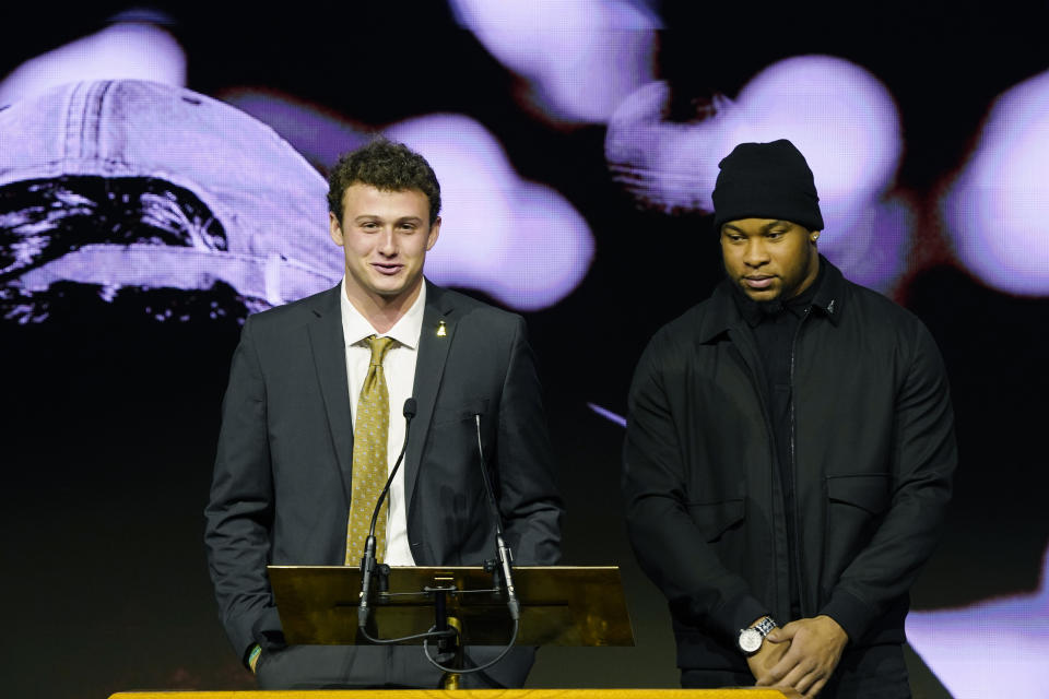Mississippi State quarterback Will Rogers, left, reflects on impact on his life by the late Mississippi State head football coach Mike Leach, while linebacker Nathaniel Watson, waits to speak during Leach's memorial service in Starkville, Miss., Tuesday, Dec. 20, 2022. Leach died, Dec. 12, 2022, from complications related to a heart condition at 61. He was in his third year as head coach. (AP Photo/Rogelio V. Solis)