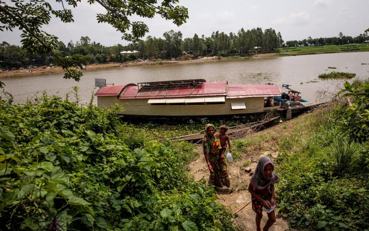 Patients leave a floating clinic after collecting medicine - Jack Taylor