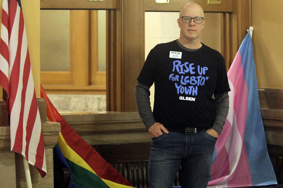 Will Rapp, the Kansas state managing director for GLSEN, a group that supports LGBTQ youth, poses for a photo during a day of lobbying at the Kansas Statehouse, Tuesday, March 28, 2022, in Topeka, Kan. His 15-year-old, Carson, identifies as bigender, or having both male and female attributes, and Will Rapp says he's discouraged by the Kansas Legislature's pursuit of multiple bills to roll back trans rights. (AP Photo/John Hanna)