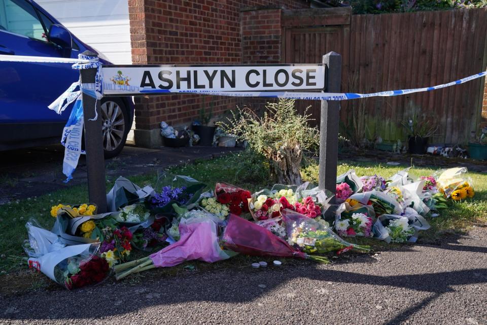 Floral tributes near to the scene in Ashlyn Close (Jonathan Brady/PA Wire)