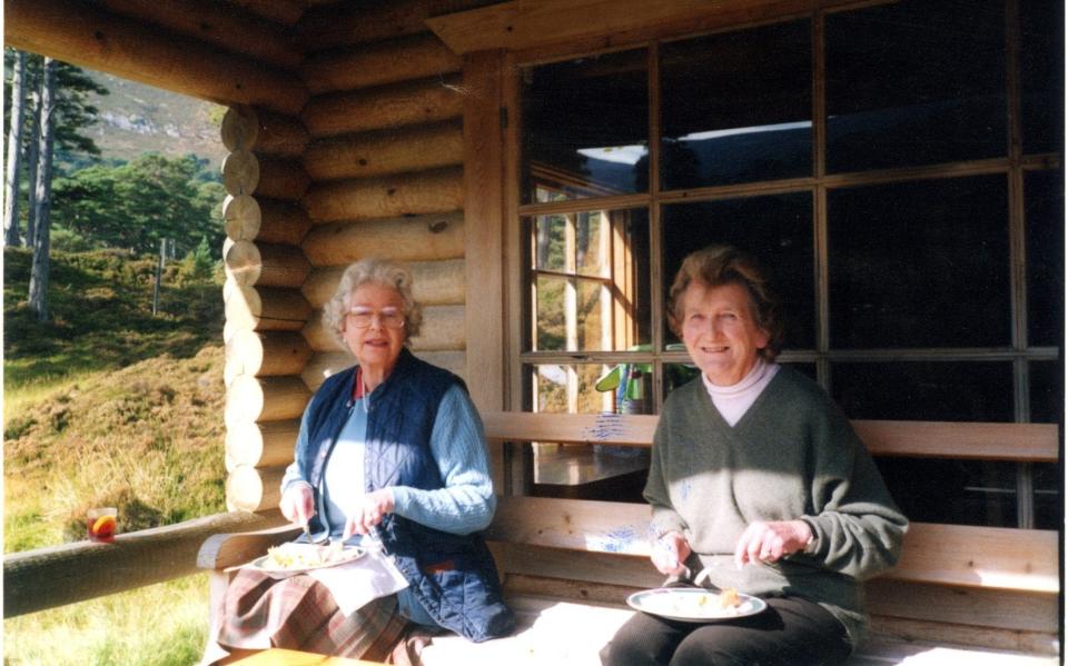 The Queen and Margaret Rhodes enjoy a relaxed lunch at Glen Beg, Her Majesty's log cabin on the Balmoral estate with the Queen's gin and Dubonnet perched on one side - MARGARET RHODES