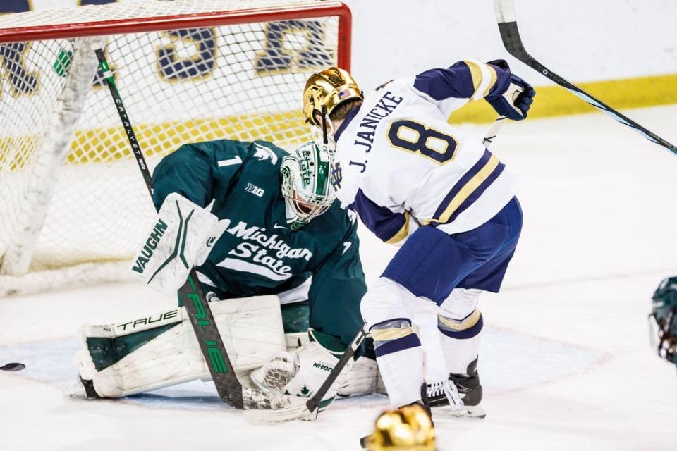 Michigan State goaltender Trey Augustine (1) makes the save on Notre Dame forward Justin Janicke (8) during the Michigan State-Notre Dame NCAA hockey game on Friday, February 02, 2024, at Compton Family Ice Arena in South Bend, Indiana.