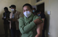 Shimray Wungreichon, 43, smiles into the camera after being administered the COVID-19 vaccine at the District Hospital in Ukhrul, in the northeastern Indian state of Manipur, Saturday, Jan. 16, 2021. Vaccine hesitancy has been a major concern as India started inoculating health workers Saturday in what is likely the world's largest COVID-19 vaccination campaign, joining the ranks of wealthier nations where the effort is already well underway. But Wungreichon is prepared. "As a health worker, this is a time when the world wants us to act,” she said.(AP Photo/Yirmiyan Arthur)