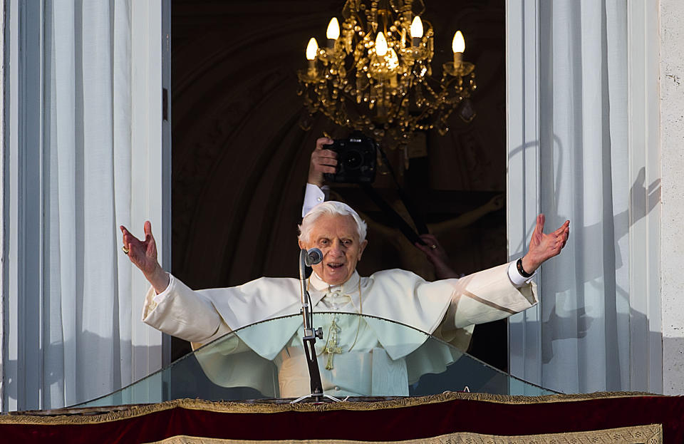 FILE - Pope Benedict XVI greets a cheering crowd gathered to see him from the balcony window of the pontifical summer residence of Castel Gandolfo, on the outskirts of Rome, before he officially ends his pontificate a few hours later, on Feb. 28, 2013. Pope Emeritus Benedict XVI, the German theologian who will be remembered as the first pope in 600 years to resign, has died, the Vatican announced Saturday. He was 95. (AP Photo/Domenico Stinellis, File)