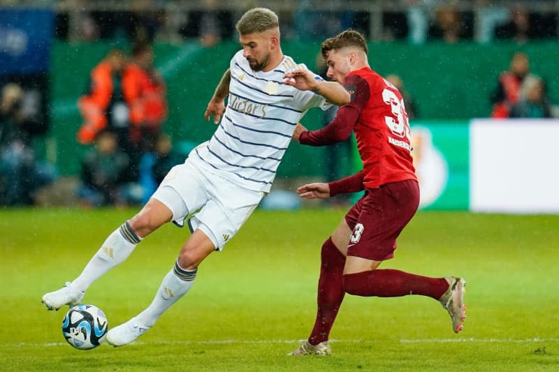 Saarbruecken's Kai Bruenker and Kaiserslautern's Jan Elvedi battle for the ball during the German DFB Cup semi-final soccer match between 1. FC Saarbruecken and FC Kaiserslautern at the Ludwigspark Stadium. Uwe Anspach/dpa