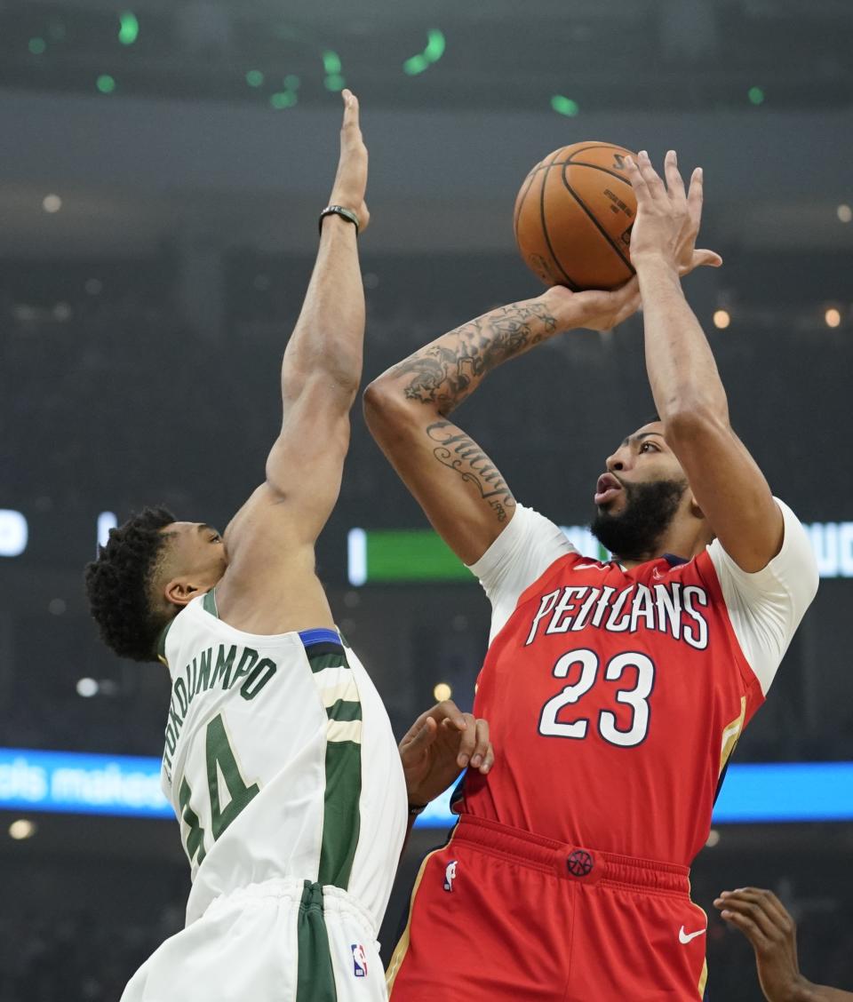 New Orleans Pelicans' Anthony Davis shoots over Milwaukee Bucks' Giannis Antetokounmpo during the first half of an NBA basketball game Wednesday, Dec. 19, 2018, in Milwaukee. (AP Photo/Morry Gash)