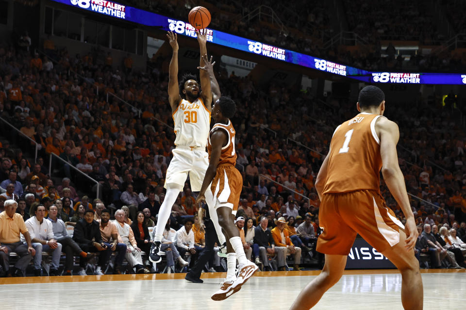 Tennessee guard Josiah-Jordan James (30) shoots over Texas guard Sir'Jabari Rice (10) during the first half of an NCAA college basketball game Saturday, Jan. 28, 2023, in Knoxville, Tenn. (AP Photo/Wade Payne)