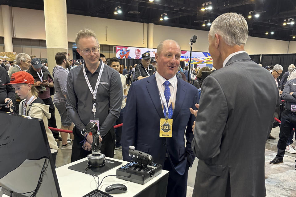 Berkshire Hathaway Vice Chairman Greg Abel checks out the flight simulators offered by one of Berkshires companies, Flight Safety as he toured the exhibit hall Friday, May 3, 2024, in Omaha, Neb. ahead of Saturday's meeting. Abel is set to succeed Warren Buffett as CEO one day. (AP Photo/Josh Funk)