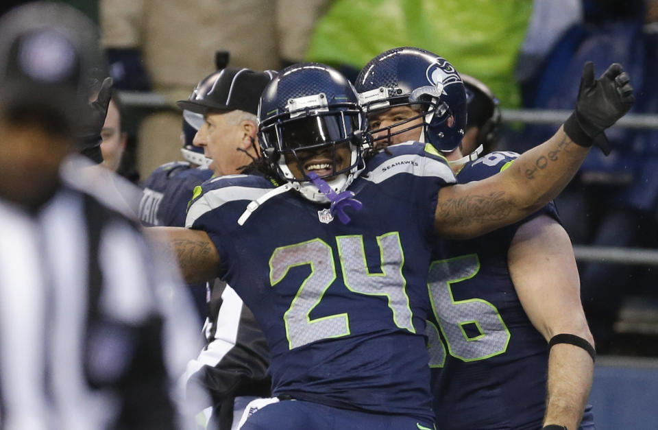 Seattle Seahawks running back Marshawn Lynch celebrates after running for a 31-yard touchdown against the New Orleans Saints during the fourth quarter of an NFC divisional playoff NFL football game in Seattle, Saturday, Jan. 11, 2014. (AP Photo/Ted S. Warren)