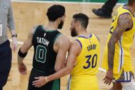Boston Celtics' Jayson Tatum (0) and Golden State Warriors' Stephen Curry (30) talk following an NBA basketball game, Saturday, April 17, 2021, in Boston. (AP Photo/Michael Dwyer)