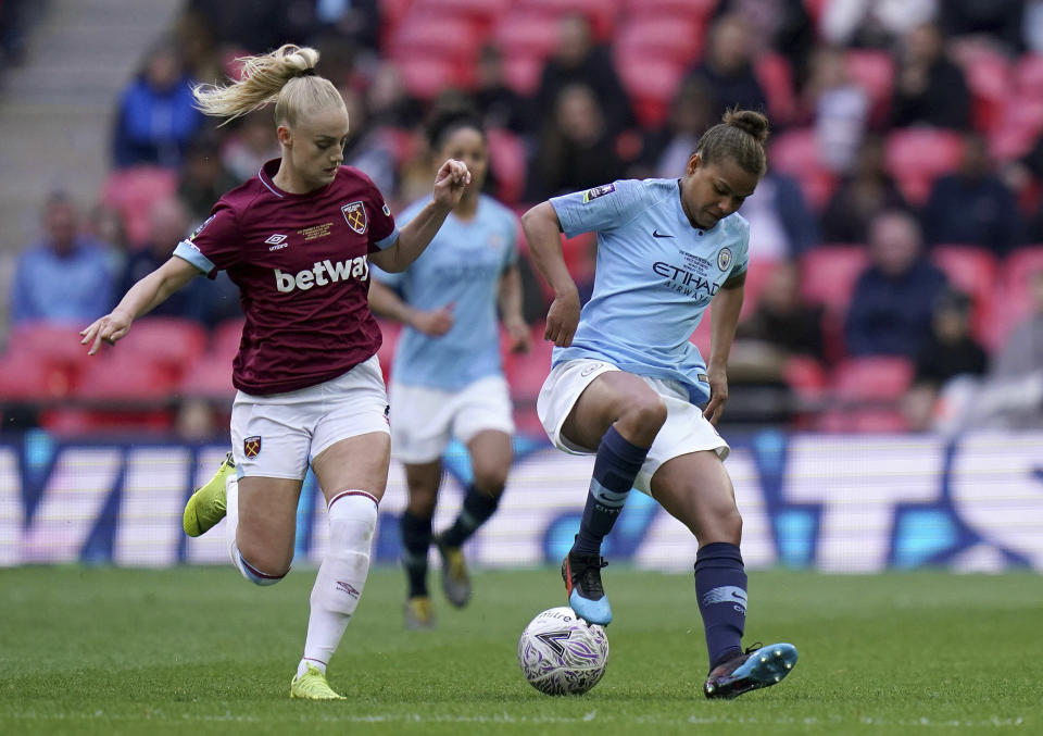 West Ham's Alisha Lehmann, left, and Manchester City's Nikita Parris battle for the ball during the Women's FA Cup Final at Wembley Stadium, London, Saturday May 4, 2019. (John Walton/PA via AP)