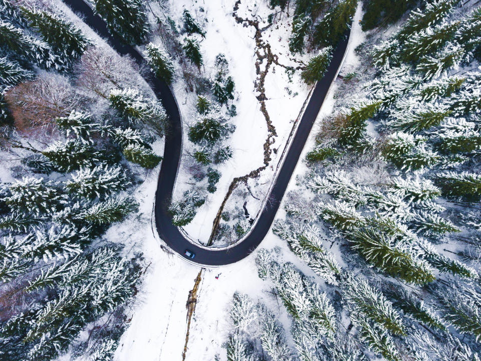 'Off Road' by @thecrowface shows a road in Germany winding through snow covered trees.