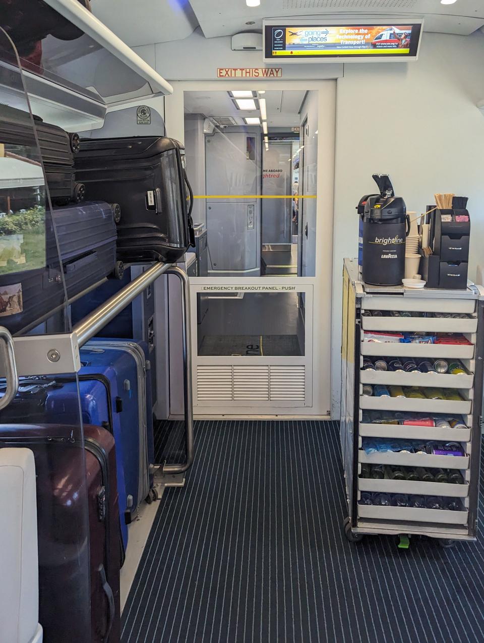 Luggage storage is shown on a Brightline train.