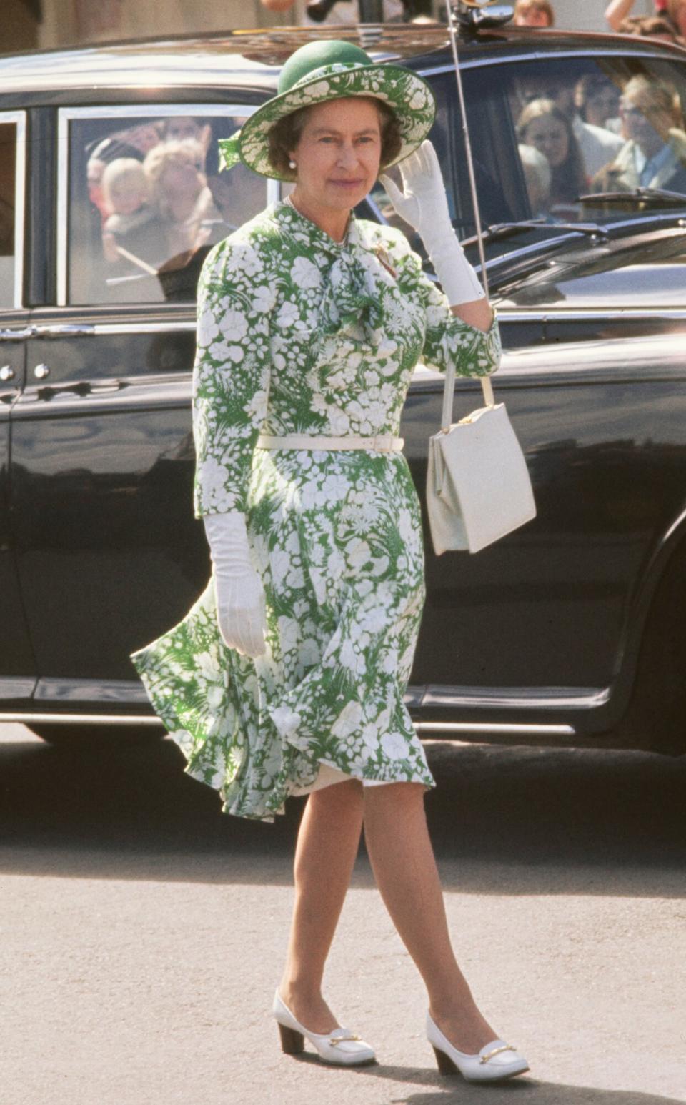 Queen Elizabeth II, wearing a green-and-white floral pattern dress with a green-and-white hat, during a walkabout in New Plymouth, New Zealand, 25th February 1977. The visit is part of the Queen's Silver Jubilee tour