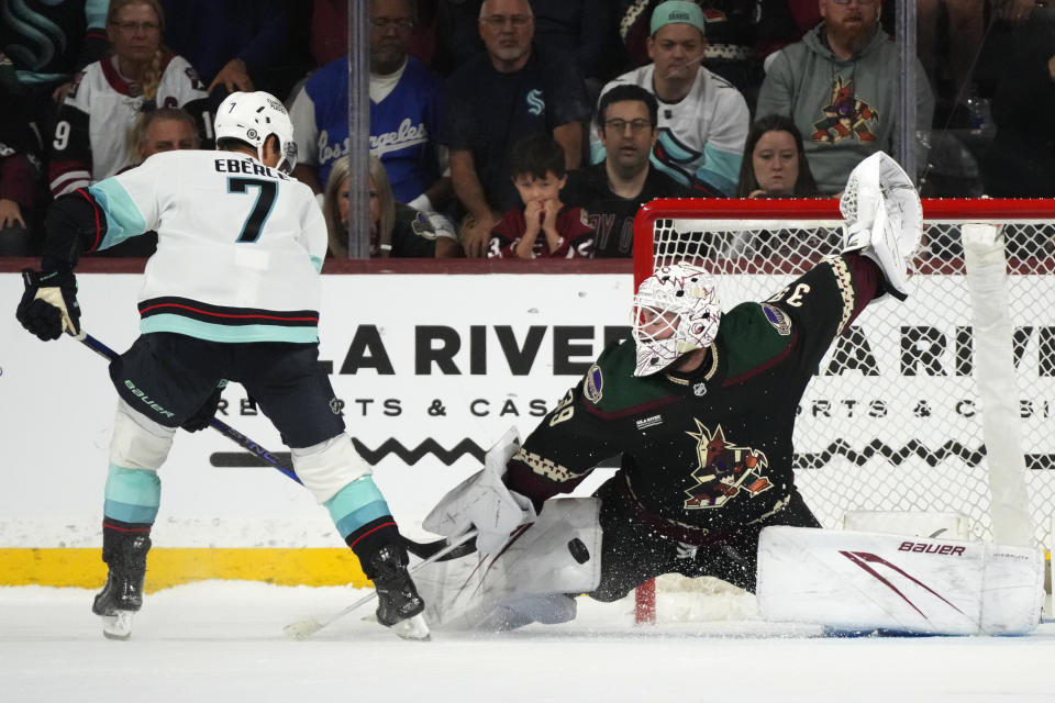 Arizona Coyotes goaltender Connor Ingram, right, makes a save on a shot by Seattle Kraken right wing Jordan Eberle (7) in a shootout during an NHL hockey game Tuesday, Nov. 7, 2023, in Tempe, Ariz. The Coyotes won 4-3. (AP Photo/Ross D. Franklin)