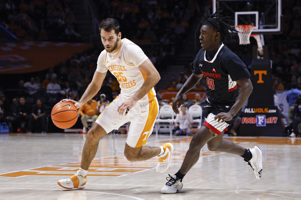 Tennessee guard Santiago Vescovi (25) drives past Austin Peay guard Guy Fauntleroy (10) during the second half of an NCAA college basketball game Wednesday, Dec. 21, 2022, in Knoxville, Tenn. (AP Photo/Wade Payne)