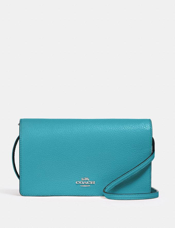 Anna Foldover Crossbody Clutch. Image via Coach.