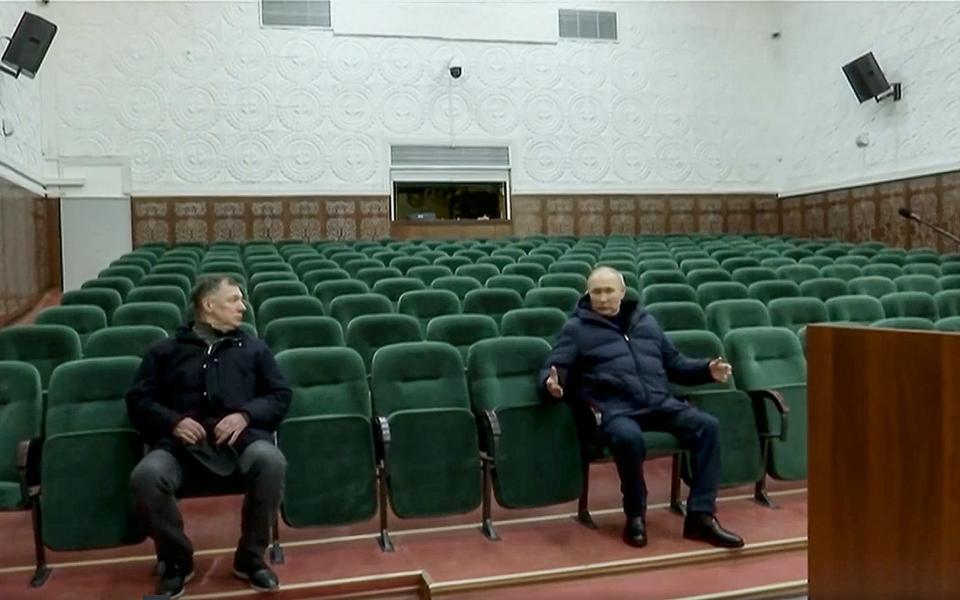 On a visit to Mariupol, Vladimir Putin gestures while speaking to Russian Deputy Prime Minister Marat Khusnullin, left, at the Mariupol theatre - POOL Russian TV/POOL Russian TV