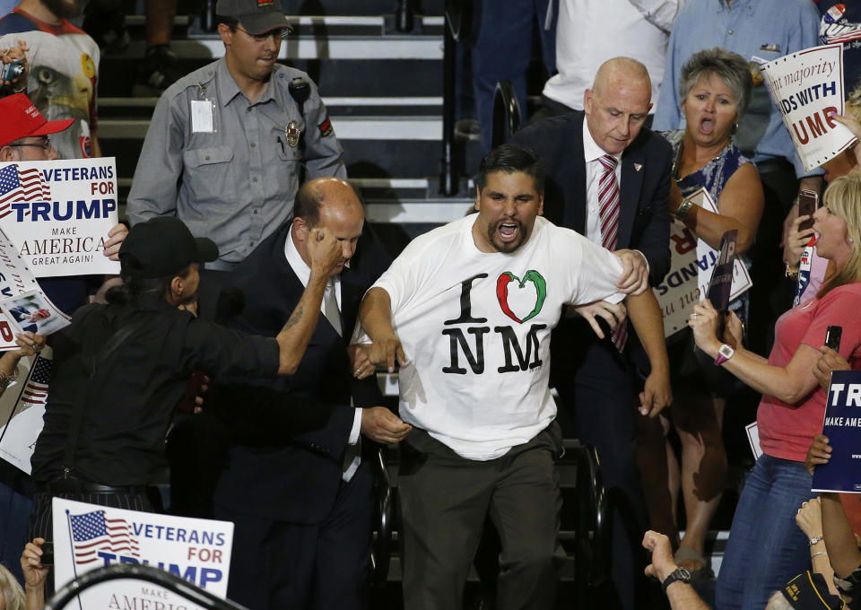 <p>A protester is taunted by Donald Trump supporters as he is removed during a speech by the Republican presidential candidate in Albuquerque, N.M., Tuesday, May 24, 2016. (AP Photo/Brennan Linsley) </p>