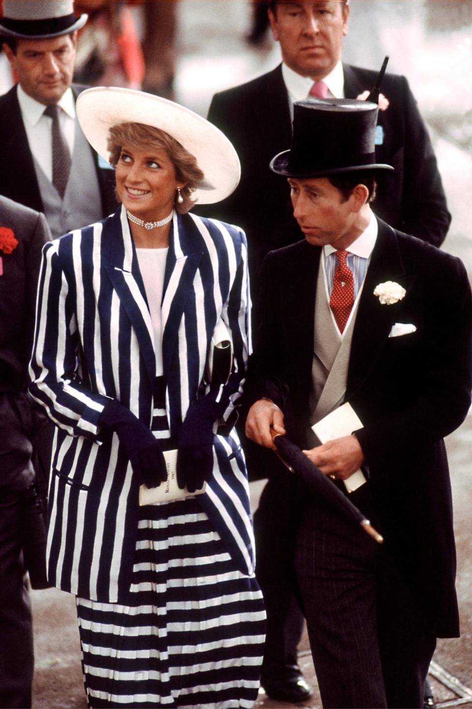 The Prince and Princess of Wales at a Royal Ascot meeting, June 1987. Diana wears a striped suit by Roland Klein and hat by Philip Somerville. (Photo by Lucy Levenson/Getty Images)