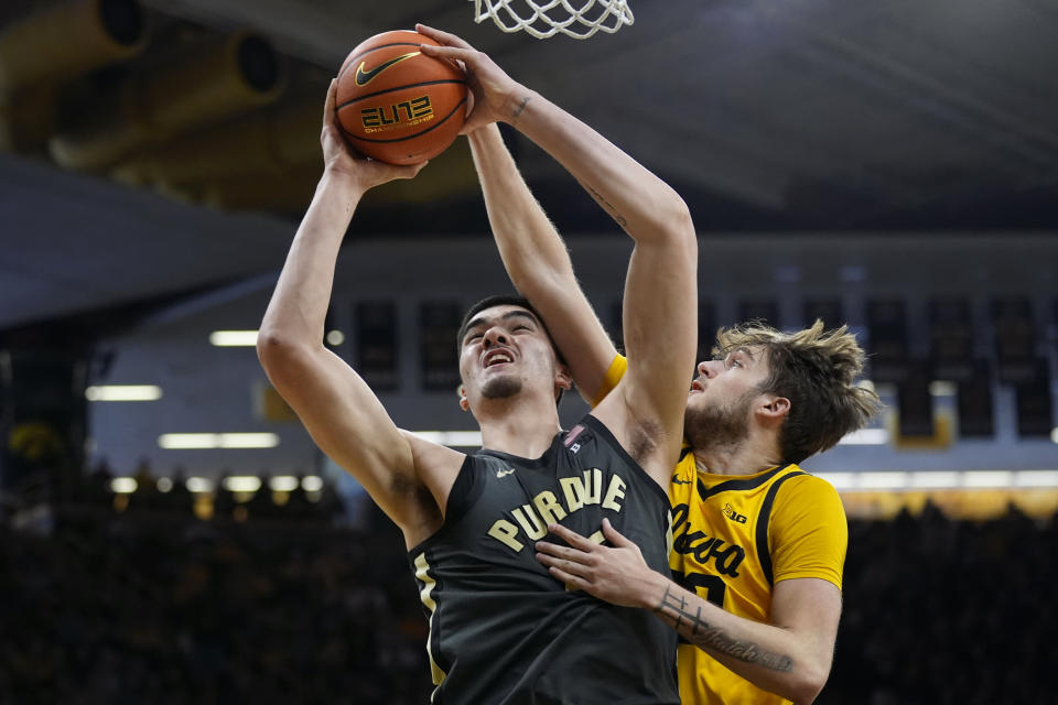 Purdue center Zach Edey shoots over Iowa forward Owen Freeman, right, during the first half of an NCAA college basketball game, Saturday, Jan. 20, 2024, in Iowa City, Iowa. (AP Photo/Charlie Neibergall)