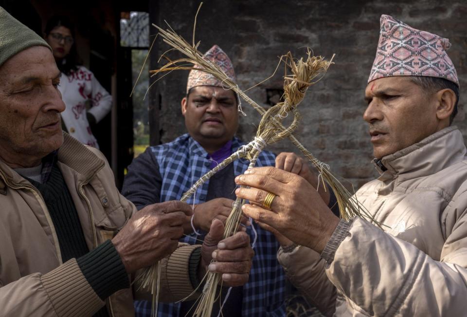 Hindu priests and relatives make a symbolic dead body of Hari Aryal (EPA)