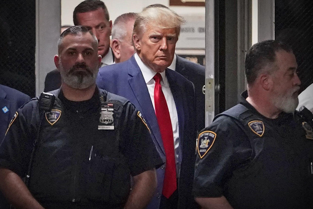 Former President Donald Trump is escorted to a courtroom in New York on April 4, 2023. (Mary Altaffer / AP file)