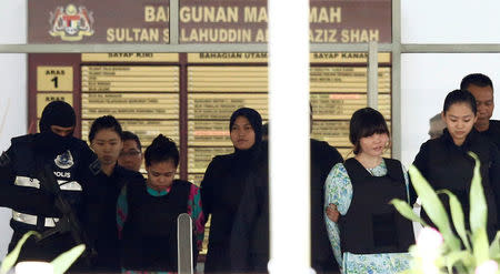 Vietnamese Doan Thi Huong and Indonesian Siti Aisyah who are on trial for the killing of Kim Jong Nam, the estranged half-brother of North Korea's leader, are escorted as they leave the Shah Alam High Court on the outskirts of Kuala Lumpur, Malaysia October 3, 2017. REUTERS/Lai Seng Sin