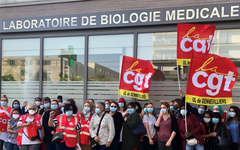 Testing clinic workers protest in front of a medical laboratory in Villeneuve-La-Garenne
