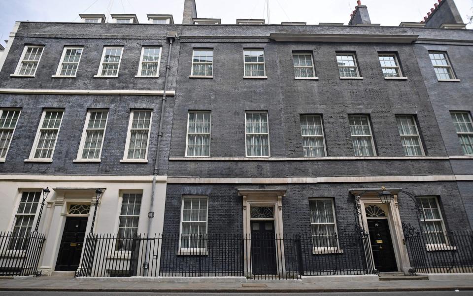 Numbers 11 (L) and 10 (R) Downing Street are pictured in central London - JUSTIN TALLIS/AFP