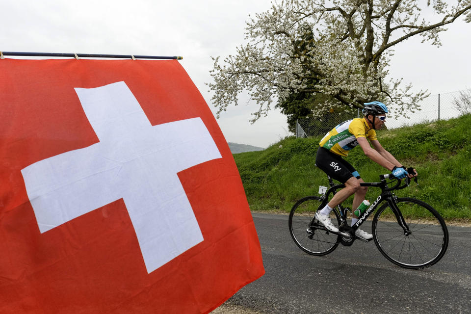 FILE - In this Friday, April 26, 2013 file photo, overall leader Chris Froome of Britain rides past a Swiss national flag during the 181 kilometer (112 mile) third stage from Payerne to Payerne at the 67th Tour de Romandie UCI ProTour cycling race near Sassel, Switzerland. Froome said Tuesday, March 4, 2014 that he wants an investigation into cycling's doping history to finally close an era dominated by Lance Armstrong. (AP Photo/Keystone, Jean-Christophe Bott, File)