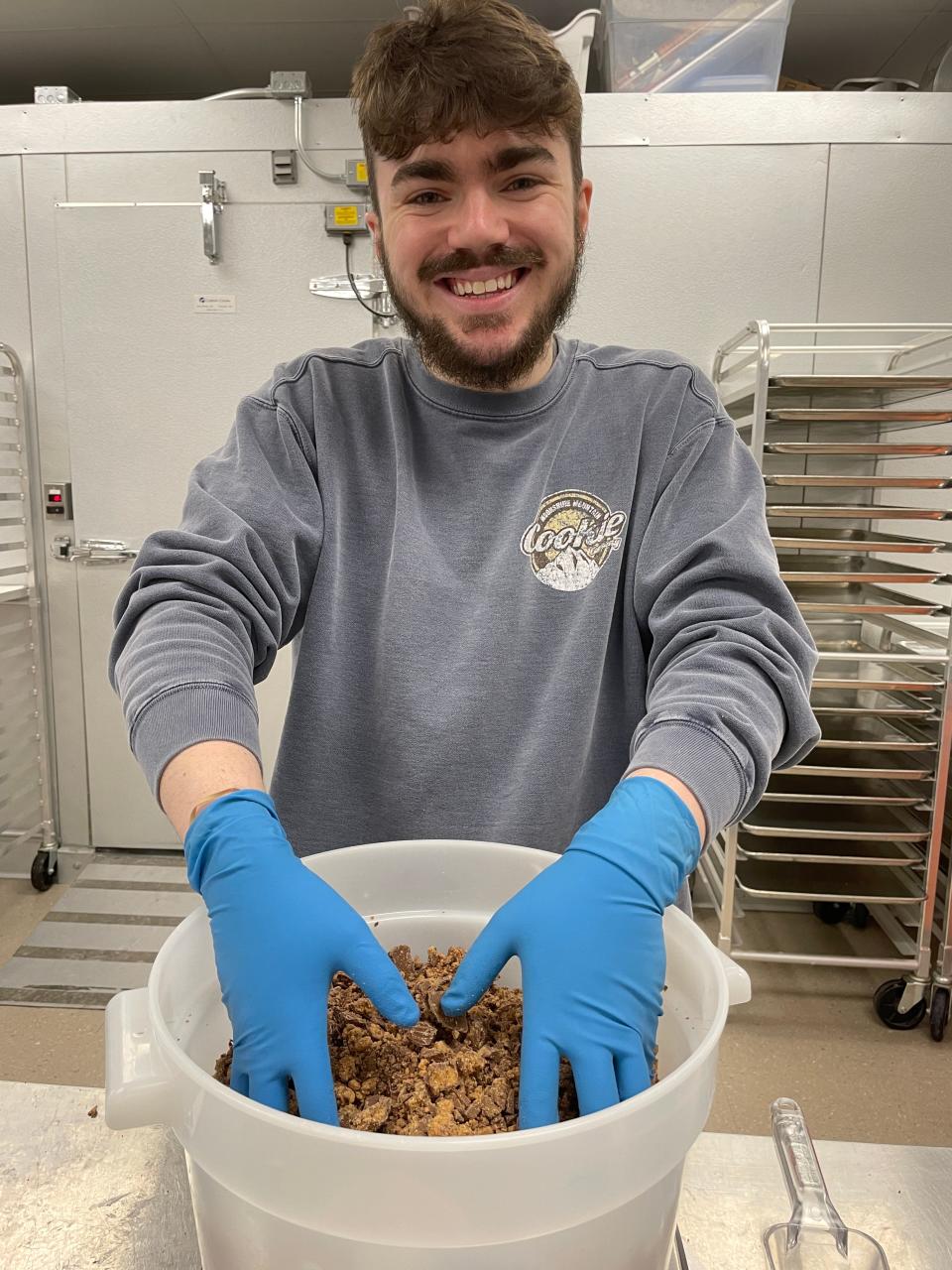 Caleb Joiner mixes peanut butter cups to make Nutty Buddy Holly cookies at Moonshine Mountain Cookie Company in Farragut, Wednesday, Jan. 5, 2022.