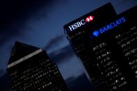 FILE PHOTO: HSBC and Barclay's buildings are lit up at dusk in the Canary Wharf financial district of London