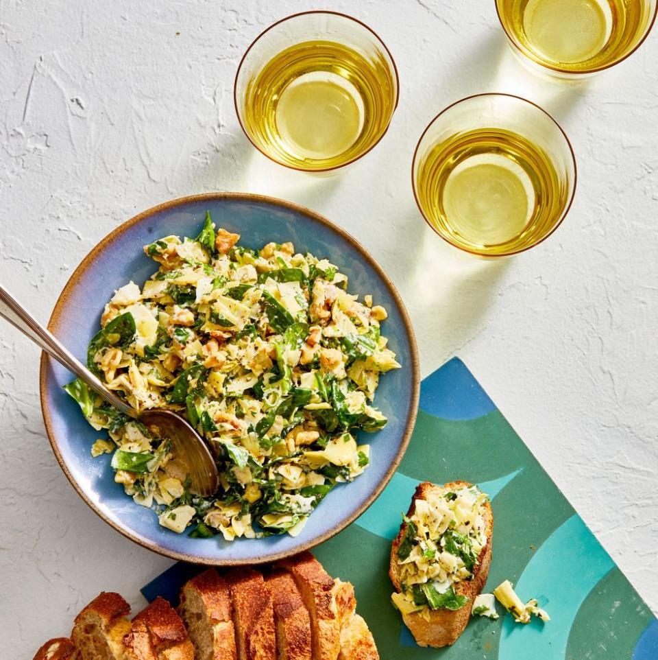 <p>We swapped out sour cream and cream cheese for extra greens, toasted walnuts and a bit of Parmesan for a lighter bite that's just as satisfying.</p><p>Get the <a href="https://www.goodhousekeeping.com/food-recipes/a28497576/best-ever-spinach-and-artichoke-dip-recipe/" rel="nofollow noopener" target="_blank" data-ylk="slk:Spinach and Artichoke Dip recipe;elm:context_link;itc:0;sec:content-canvas" class="link "><strong>Spinach and Artichoke Dip recipe</strong></a>.</p>