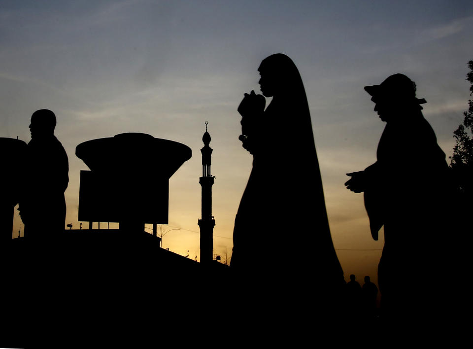 Pilgrims walk outside Namira Mosque in Arafat, in Mecca, Saudi Arabia, Friday, Aug. 9, 2019. More than 2 million pilgrims were gathered in the holy city of Mecca in Saudi Arabia on Friday to perform initial rites of the Hajj, an Islamic pilgrimage that takes the faithful along a path traversed by the Prophet Muhammad some 1,400 years ago. (AP Photo/Amr Nabil)