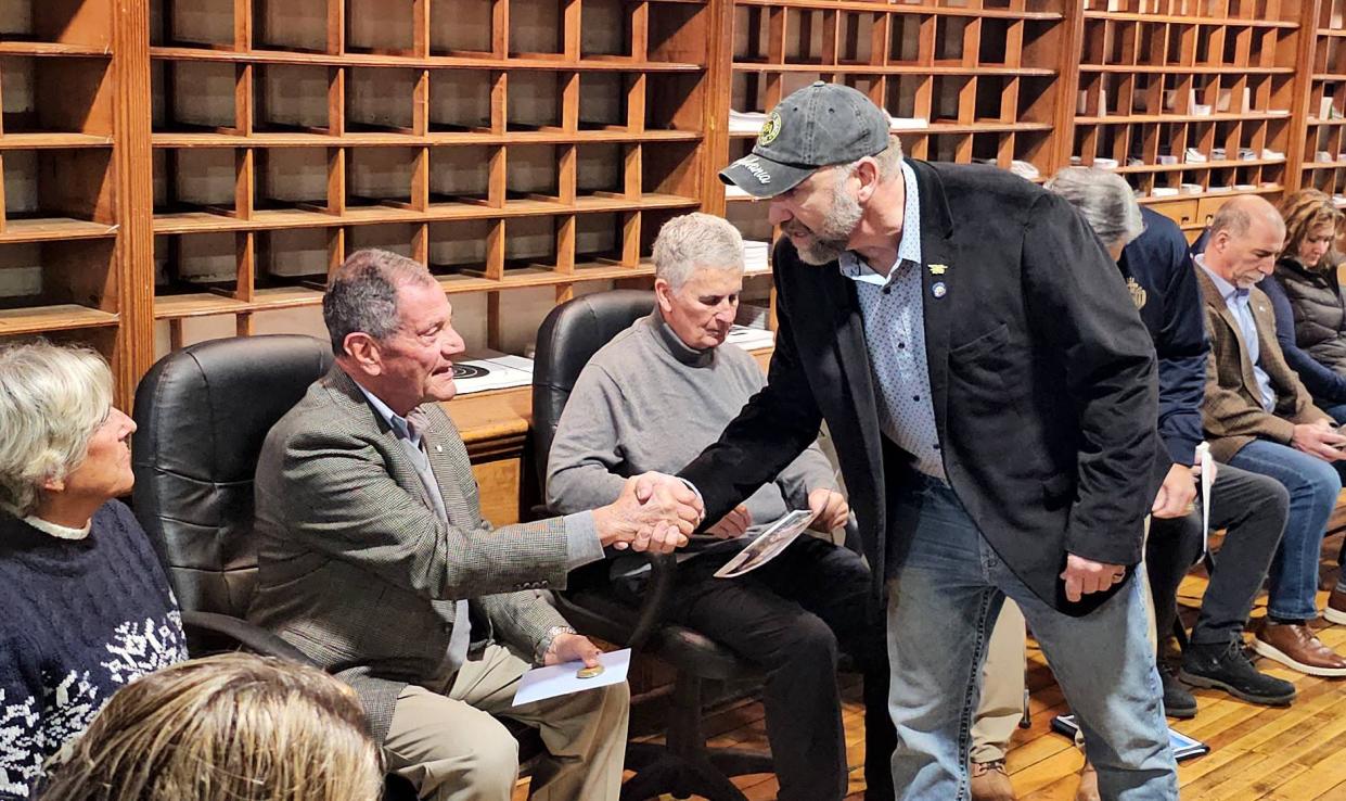 Melanie Mellon, left, watches as her husband, M. Richard Mellon, shakes hands with state Rep. Jake Banta during a meeting Saturday at Banta's North East office. The Mellons plan to buy Granite Ridge and open a veterans outreach and wellness center.