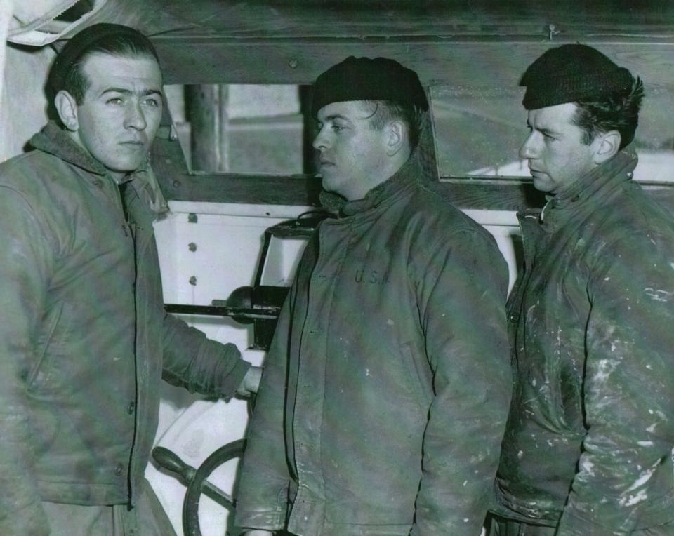 Left to right: U.S. Coast Guard Boatswain's Mate Bernie Webber, then-age 24; Seaman Richard Livesey, 22; and Engineer Andy Fitzgerald, 20, are seen at the helm of the small boat they had just used in the harrowing rescue of survivors off the sinking Pendleton oil tanker, which split in half at sea on Feb. 18, 1952. Not pictured is Seaman Ervin Maske,  23, who was also part of the four-man rescue team.