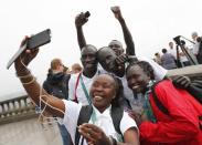 2016 Rio Olympics - Christ the Redeemer - 30/07/2016. Members of the Olympic refugee team pose for selfies in front of Christ the Redeemer. REUTERS/Kai Pfaffenbach