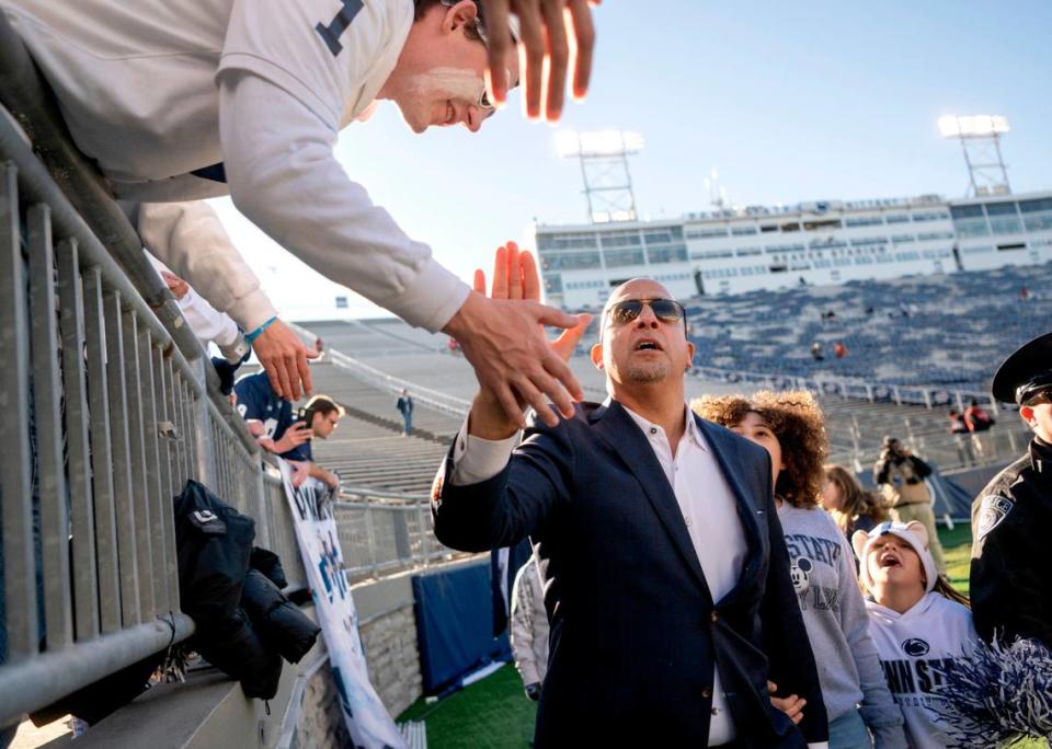 Penn State football coach James Franklin high fives students and thanks for arriving early before the game against Michigan State at Beaver Stadium on Saturday, Nov. 26, 2022.