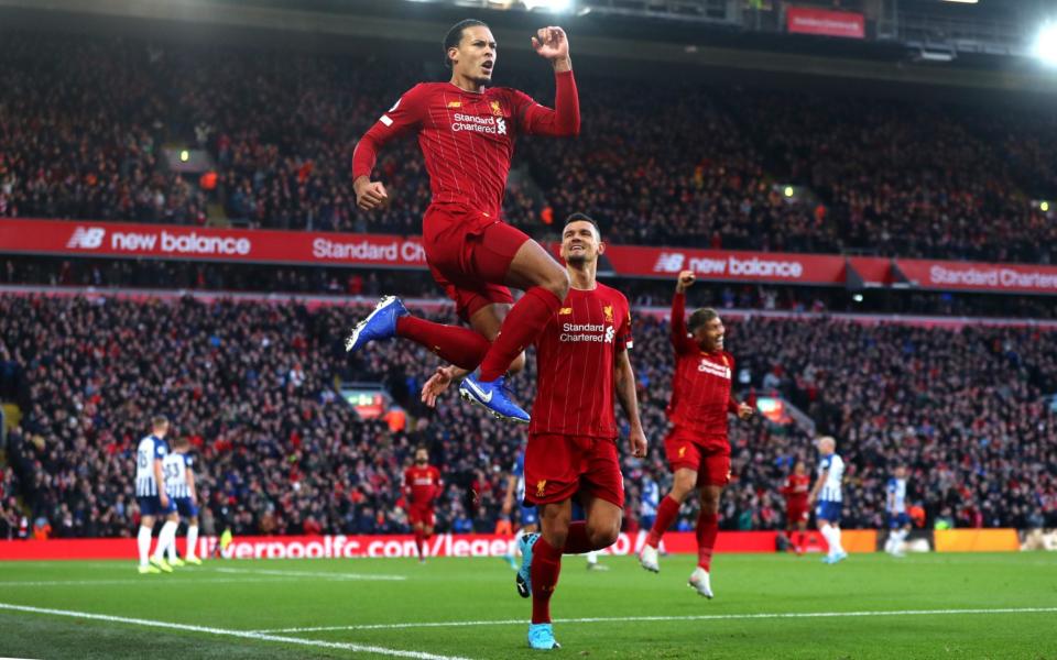 Virgil Van Dijk of Liverpool celebrates scoring his teams first goal during the Premier League match between Liverpool FC and Brighton & Hove Albion - Getty Images Europe