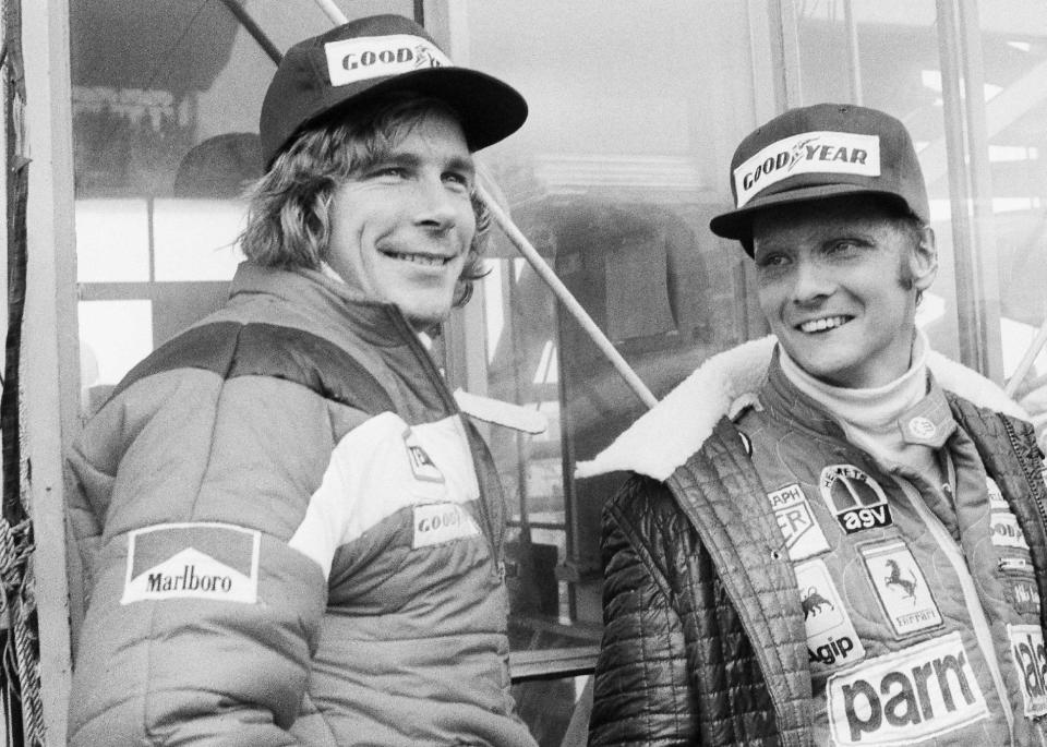 FILE - In this Oct. 24, 1976, file photo, Austrian auto racer Niki Lauda, right, defending champion in world driving, and James Hunt, of Britain, look at the rain before the start of the Japan Grand Prix Formula One auto race at Fuji International Speedway, Gotemba, Japan. Director Ron Howard was not particularly a racing fan when he began making "Rush," the movie chronicling Formula One's 1976 world championship between Lauda and Hunt. By the time he was finished, Howard was hooked, and the completed project is what some consider the most authentic racing film ever made. (AP Photo/Nick Ut, File)