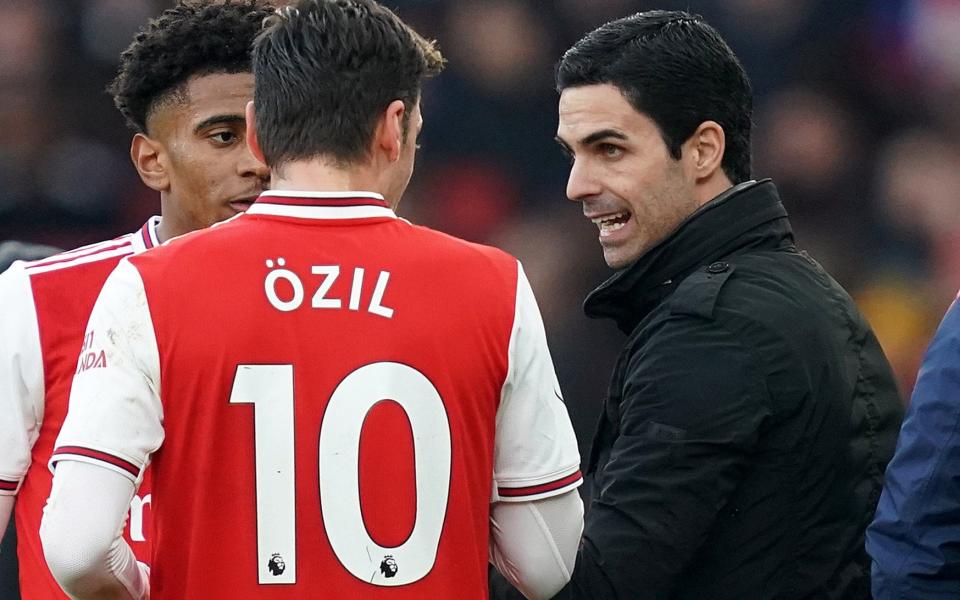 Mikel Arteta chats with Mesut Ozil - PA