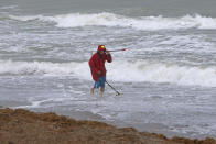 Local resident Mike Squillace looking for metal at Dania Beach, Fla., as Tropical Storm Gordon pass by South Florida with wind gust and heavy rainfall for the Labor Day holiday on Monday, Sept. 3, 2018. (David Santiago/Miami Herald via AP)