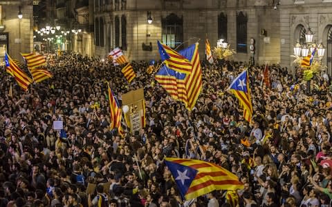 Pro-independence supporters celebrate following the parliamentary vote - Credit: Angel Garcia/Bloomberg